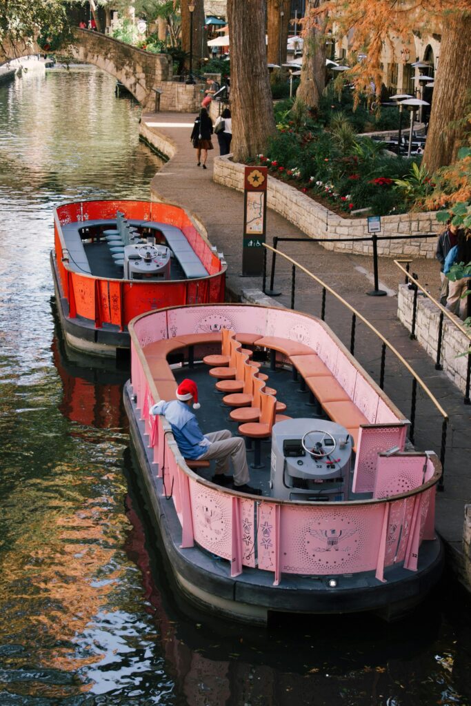 Vibrant passenger boats docked at a scenic urban riverbank, perfect for city tourism.
