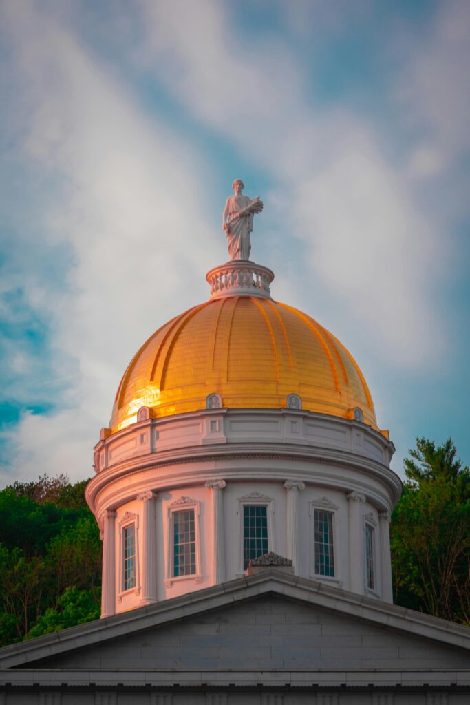 Capture of the iconic golden dome atop Vermont State House in Montpelier during daylight.
