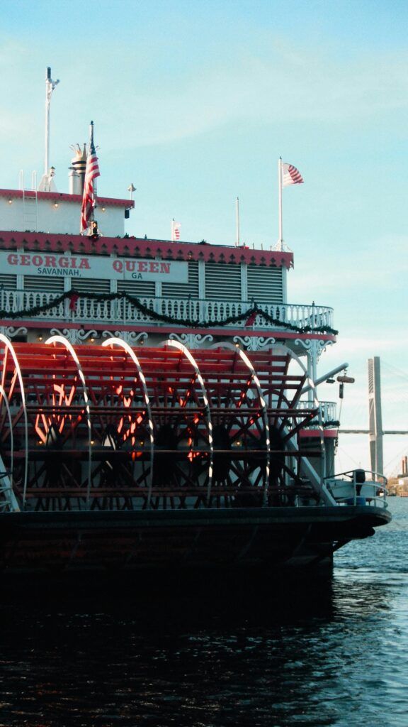 A classic Georgia Queen steamboat on the Savannah River with stunning bridge backdrop.